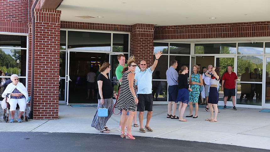 People gather outside St. Brendan the Navigator Church after Mass Aug. 19.