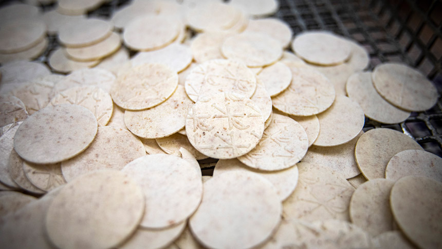  Freshly baked and cut altar bread is waiting to be sorted in the bakery at the Monastery of St. Clare in Langhorne, Pa., July 21, 2021. The monastery produces up to 3 million altar breads a year, selling what may eventually become consecrated hosts to parishes throughout Pennsylvania and other parts of the U.S. (CNS photo/Chaz Muth)