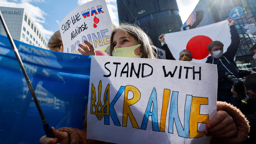 A Ukrainian residing in Japan shows a placard during a protest rally denouncing Russia over its actions in Ukraine, near the Russian Embassy in Tokyo Feb. 23, 2022. Pope Francis expressed "great sorrow" over the situation in Ukraine and called on Christians to observe a day of prayer and fasting for peace on Ash Wednesday, March 2. (CNS photo/Issei Kato, Reuters)