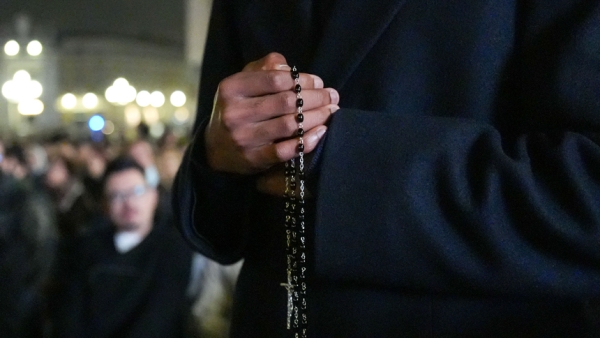 A priest holds a rosary as he joins Cardinal Luis Antonio Tagle, pro-prefect of the Dicastery for Evangelization, cardinals living in Rome, officials of the Roman Curia and other faithful in praying for Pope Francis Feb. 25, 2025, in St. Peter's Square at the Vatican. (CNS photo/Lola Gomez)